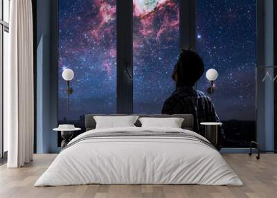 person standing next to the window and watching outside, admire the star on night sky, elements of this image furnished by nasa Wall mural