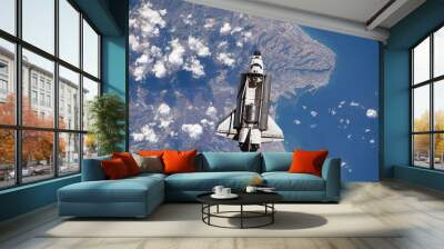 space ship shuttle flying near earth from the hurricane and massive clouds in atmosphere, image made of NASA photos f Wall mural