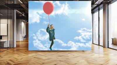 the concept of carefree and life enjoy, dream come true, person with balloon fly high in the air Wall mural