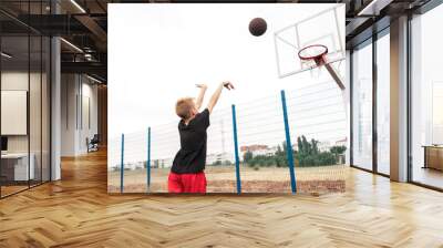 young boy kid shooting a basketball in the hoop Wall mural