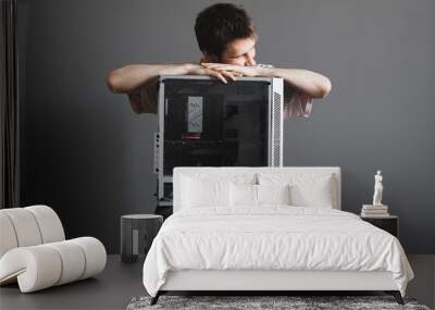 young male person holding a new gamer pc desktop computer Wall mural