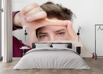 young man make a hand frame over his face on bright background b Wall mural