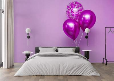 stylish birthday party or holidays with balloons. pink  balloons on the pink background with copy space for text. Hand  holding three bright colorful balloons indoor. Wall mural