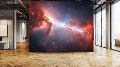 A captivating orange and red galaxy bursts through a starry cosmos field, offering both beauty and a sense of wonder as it lights up this celestial landscape. Wall mural