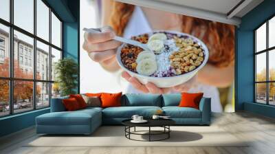 Acai bowl woman eating morning breakfast at cafe. Closeup of fruit smoothie healthy diet for weight loss with berries and oatmeal. Organic raw vegan healthy food. Wall mural