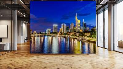 Frankfurt am Main. European finance center city downtown skyline cityscape. Eiserner steg bridge, river during twilight blue hour, sunset, evening, night. Gold yellow color. Travel in Hesse, Germany. Wall mural