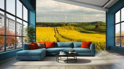 Blooming rapeseed, windmills and storm clouds - panorama of the agricultural landscape of Germany Wall mural