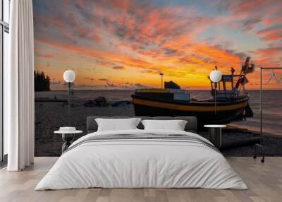 Fishing boats on the sea beach during the spectacular sunrise Wall mural