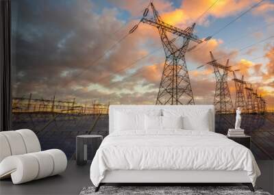 Solar panels with  electricity pylon at sunset. Clean energy concept Wall mural