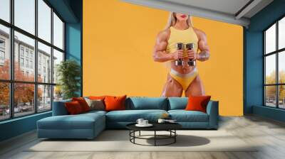 Athlete bodybuilder. Strong athletic woman on steroids with dumbbells on yellow background wearing in sportswear. Fitness and sport motivation. Wall mural