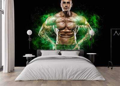 Athlete in green energy lights. Muscular young fitness sports man bodybuilder. Workout in fitness gym. Copy space for fitness nutrition ads. Wall mural