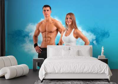 Fit couple at the gym isolated on white background. Fitness concept. Healthy life style. Wall mural