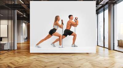 Fit couple at the gym isolated on white background. Fitness concept. Healthy life style. Wall mural