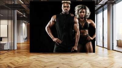 Fitness couple of athletes posing on black background, healthy lifestyle body care. Sport concept with copy space. Wall mural