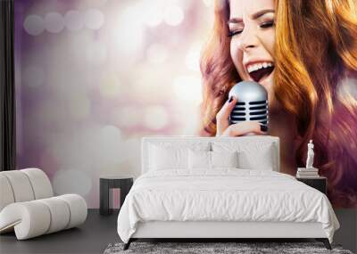 Glamor fashion Woman with Microphone over Blinking bokeh night background.  Wall mural