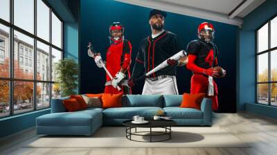 Group of athletes. Porfessional american football player in helmet with ball, lacrosse player with stick, and baseball player with bat. Sport and motivation wallpaper. Wall mural