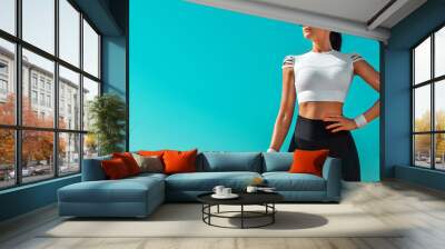 Individual sports and fitness recreation. Sporty and fit young woman athlete relaxed after yoga training on the sky background. The concept of a healthy lifestyle and sport. Wall mural