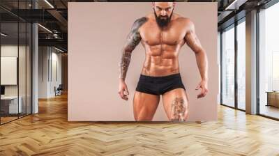 Muscular young fitness sports man with strong fit body on light background. Wall mural