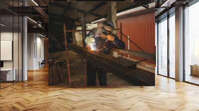 El Oro / Ecuador - 2017 : A welder at his job, welding metal bars together Wall mural