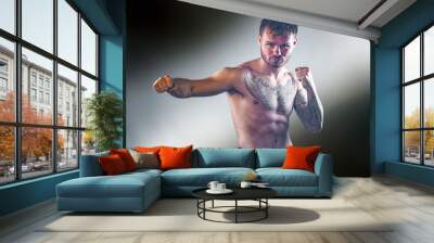 young boxer without shirt baring tattoos  Wall mural