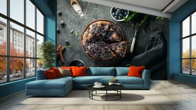 Flat lay with sliced homemade blueberry pie on dark background  Wall mural