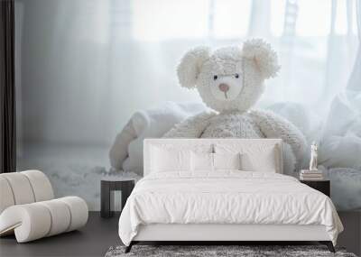 A cozy white teddy bear sits on a soft rug in a bright, airy room with sheer curtains and soft blankets around midday Wall mural