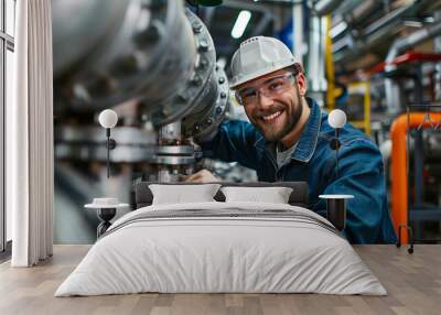 Smiling engineer working on industrial machinery in factory. Wall mural