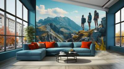 Three hikers admire mountain view from summit Wall mural