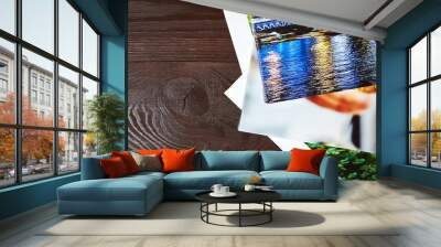 Canvas prints on brown wooden background with copy space. Photos with gallery wrap method of canvas stretching on stretcher bar. Colorful photographs printed on glossy synthetic canvas, top view Wall mural