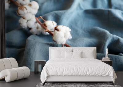 Cotton plant with white flowers on blue fabric Wall mural