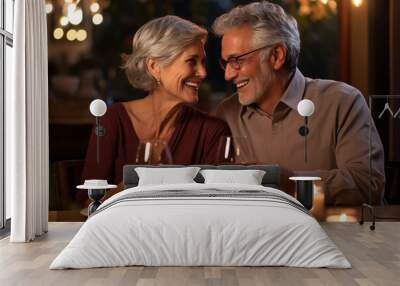 Happy senior couple having romantic dinner in restaurant together. They are looking at each other and smiling. Cheerful elderly man and woman celebrating Valentines Day Wall mural