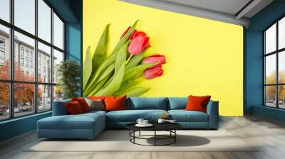 Red tulips on yellow background. Fresh spring flowers Wall mural