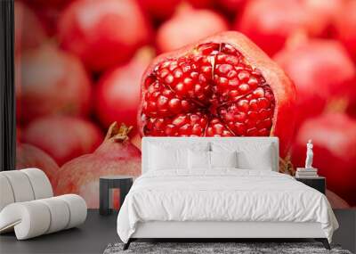 Ripe pomegranate fruit with red flesh and seeds, food background. Heap of fresh pomegranates Wall mural