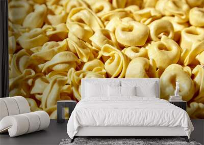 Tortellini pasta with prosciutto food background. Italian stuffed pasta Wall mural