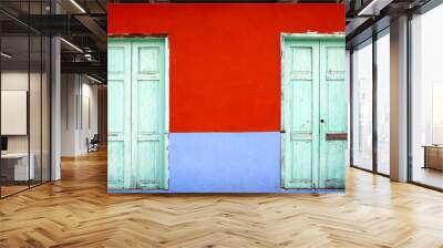 close up on colorful mediterranean style facade with two wooden doors as background Wall mural