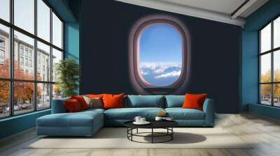 Airplane window. Mountain and clouds view Wall mural