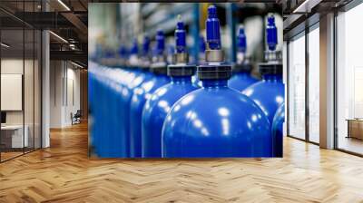 Close-up of blue industrial oxygen tanks arranged in a line within a production facility, highlighting industrial equipment and safety in manufacturing environments Wall mural