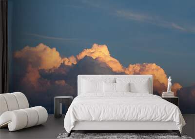 Dramatic view of a orange clouds in the dark evening sky Wall mural