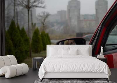 girl wears a medical mask while sitting in the car Wall mural