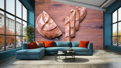 Sliced rye bread on an old wooden table,close-up Wall mural