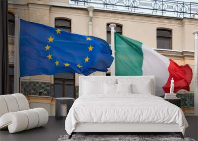 View of the flags of Italy, the European Union on the background of the building Wall mural