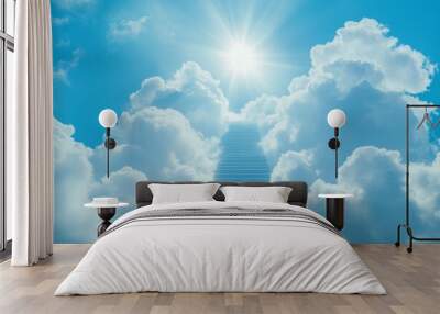 A serene blue sky with white clouds forms a radiant staircase to heaven illuminated by sunlight Wall mural