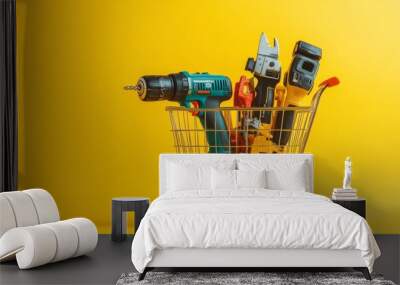 Shopping basket with electric tools  angle grinder, drill, and jigsaw on yellow background Wall mural