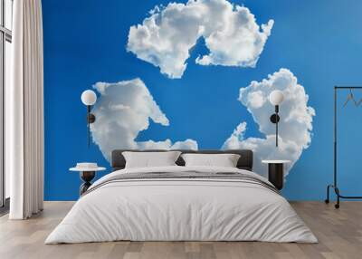 White fluffy clouds forming recycle symbol in clear sky, representing environmental awareness and sustainability Wall mural