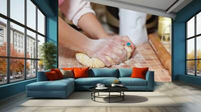 close up of girl making pasta the traditional way Wall mural