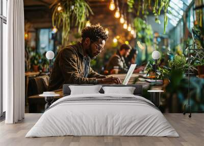 Office workers working in a coworking, with lots of green plants, a comfortable environment for productive work Wall mural