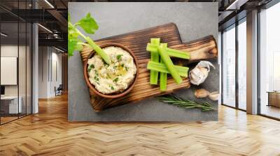 Flat lay view at vegetable Hummus dip dish topped with chickpeas and olive oil served with celery slices Wall mural