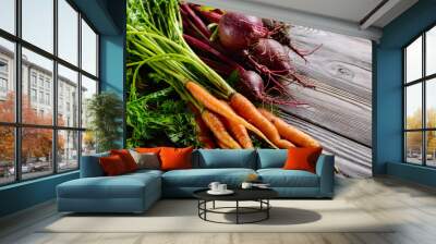 Fresh organic beetroots and carrots on kitchen wooden rustic table close up view Wall mural