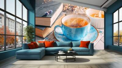 a cup of delicious and fragrant spring tea in a blue mug in the morning sun Wall mural