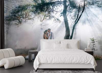 bride and groom on the background of fairy fog in the forest. Rustic wedding concept Wall mural